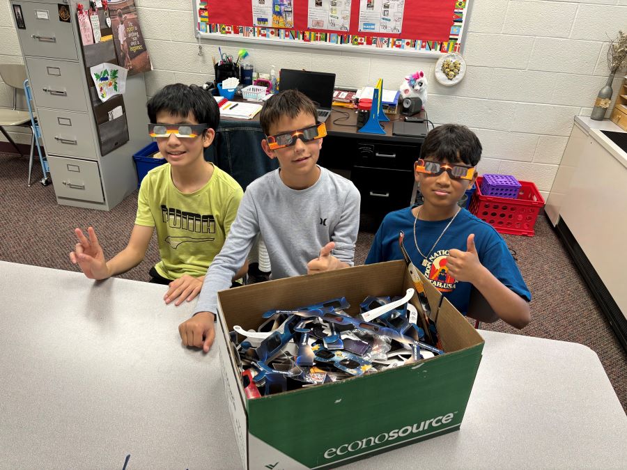 Students Helping Box Eclipse Glasses